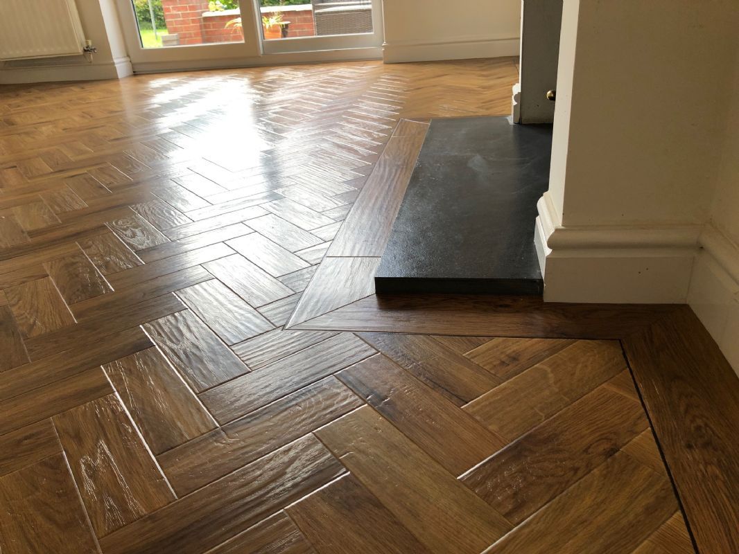 Oak herringbone floor Shaun fitted, running up to a stone hearth in a Cotswold home