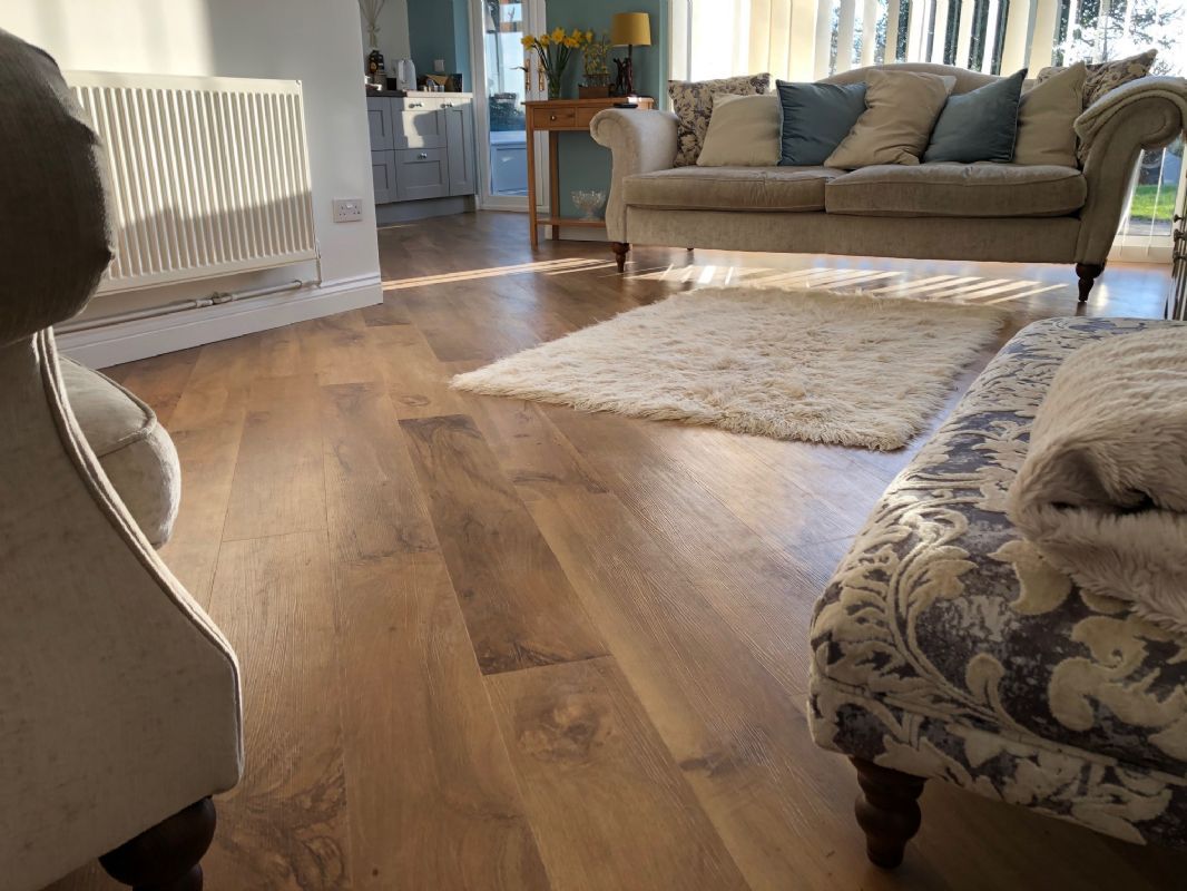 Oak-effect luxury vinyl planks Shaun fitted through a sunlit living room