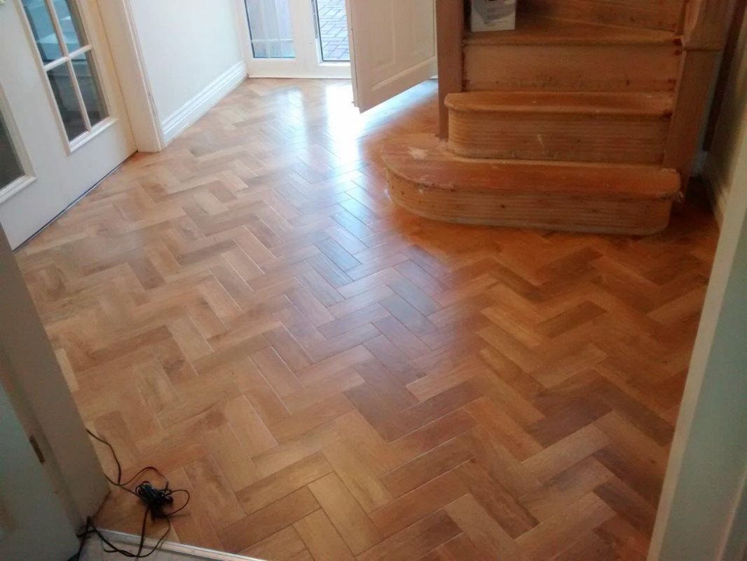 A design parquet floor laid by Shaun Venn, running through to a staircase